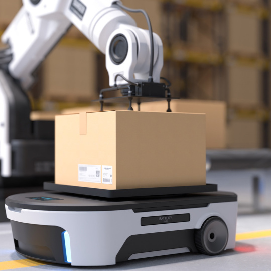 Un brazo robótico coloca una caja de cartón en un robot autopropulsado.